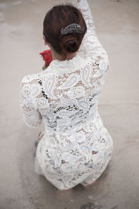 Rear view of a girl standing in white background