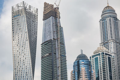 Low angle view of buildings in city against sky