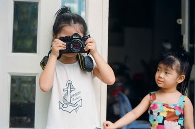 Portrait of a girl holding camera