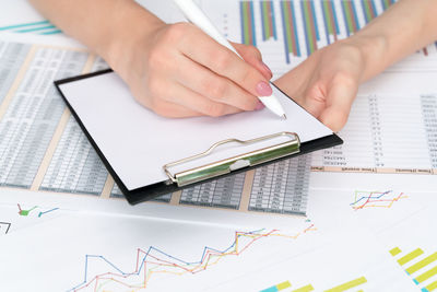 High angle view of person reading book on table