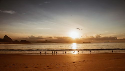 Scenic view of beach against sky during sunset