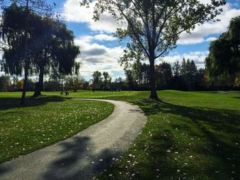 Scenic view of golf course against sky