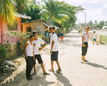 Group of people walking on sidewalk in city