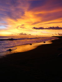 Scenic view of beach against sky during sunset