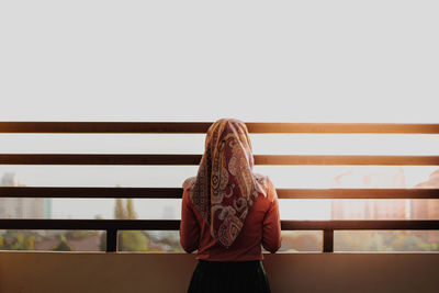 Woman standing against railing