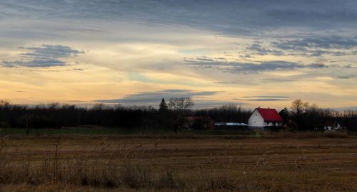 Scenic view of field against sky during sunset