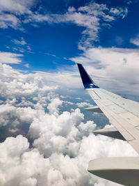 Airplane wing over cloud