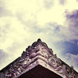 Low angle view of building against cloudy sky