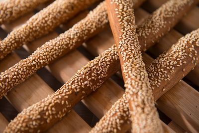 High angle view of fresh breadsticks on wooden board