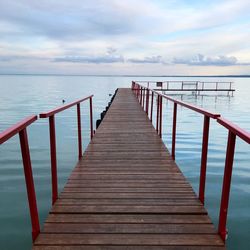 Pier over sea against sky