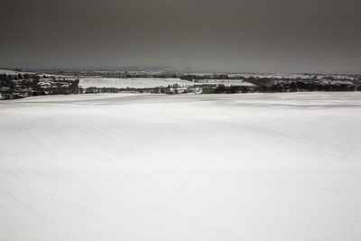 Frozen landscape against clear sky