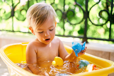 Cute boy playing with toy in park