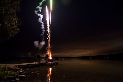 View of bridge over river against sky at night