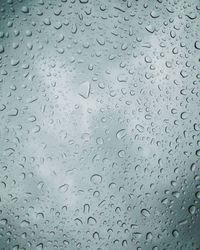 Full frame shot of raindrops on glass window