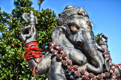 Low angle view of statue against sky