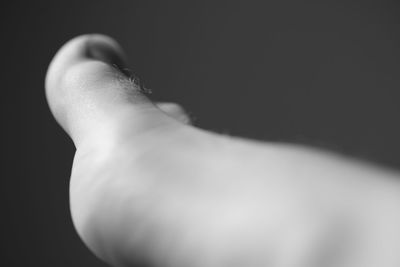 Low section of person against black background