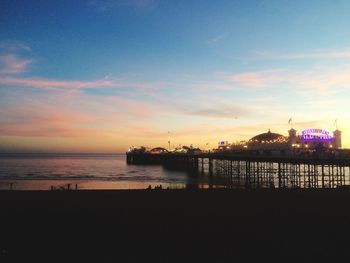 Silhouette pier on sea against sky during sunset