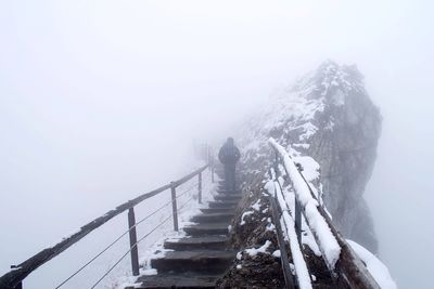 People standing on snow covered mountain