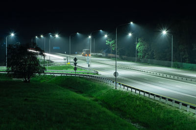 View of illuminated street lights at night