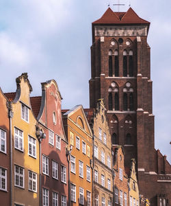 Low angle view of buildings in town against sky