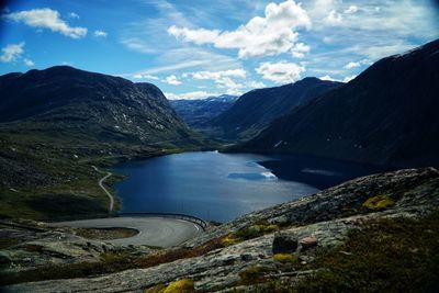 Scenic view of lake and mountains against sky