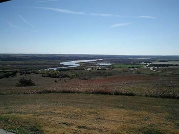 Scenic view of field against blue sky