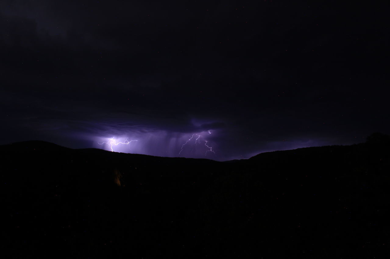 night, beauty in nature, sky, lightning, power in nature, darkness, cloud, mountain, environment, storm, scenics - nature, thunderstorm, silhouette, no people, nature, dramatic sky, dark, thunder, landscape, warning sign, outdoors, awe, illuminated, star