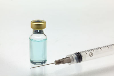 Close-up of glass bottle against white background