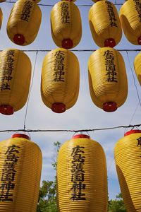 Low angle view of lanterns hanging against sky