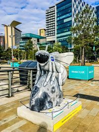 Statue against buildings in city