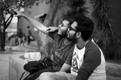 Cheerful friends sitting outdoors