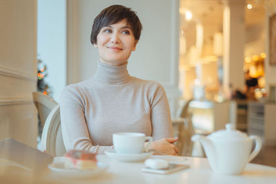 Smiling woman sitting in cafe