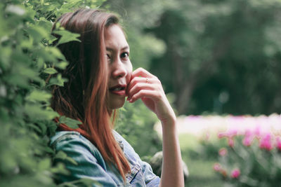 Portrait of woman against plants