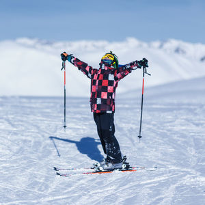 Boy skiing on snowcapped mountain