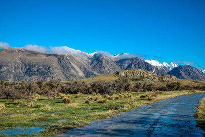 Scenic view of mountains against clear blue sky