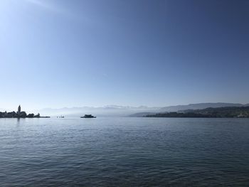 Scenic view of sea against clear blue sky