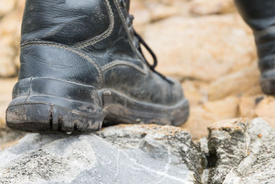 Low section of man standing on rock