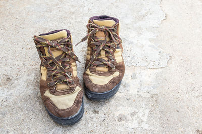 High angle view of shoes on concrete wall