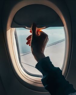 Man seen through airplane window