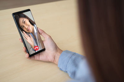 Midsection of woman using mobile phone