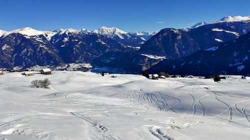 Scenic view of snow covered mountains against sky