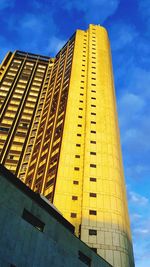 Low angle view of modern building against blue sky