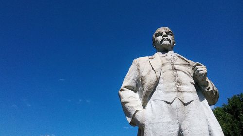 Low angle view of statue against clear blue sky