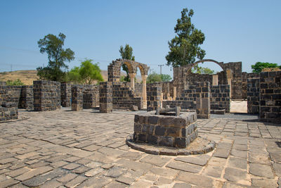 Old ruins in city against sky