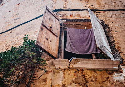 Low angle view of clothes drying against building