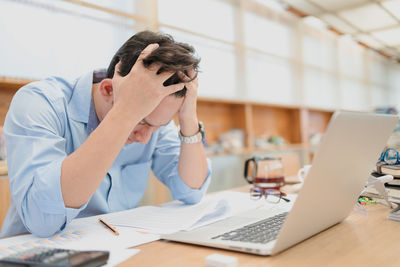 Frustrated businessman sitting at office