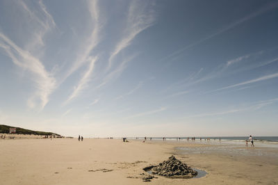 Scenic view of beach against cloudy sky