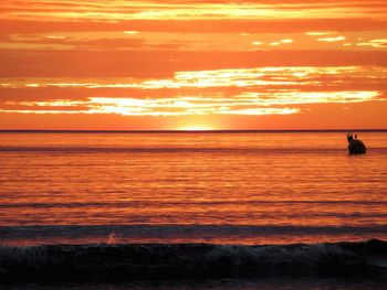 Scenic view of sea against orange sky