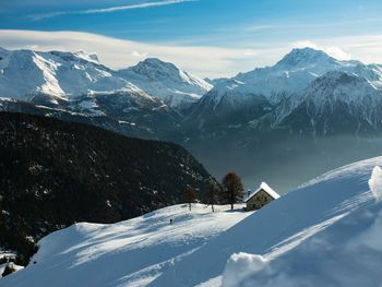 Scenic view of snowcapped mountains against sky