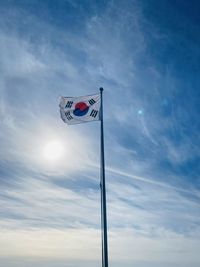 Low angle view of flag against sky